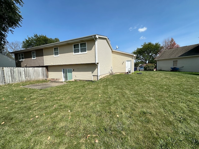 back of property with a patio and a yard