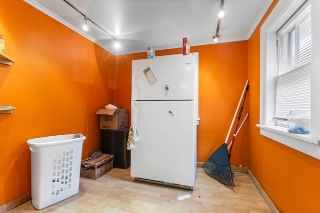 kitchen with light hardwood / wood-style flooring, white fridge, crown molding, and rail lighting