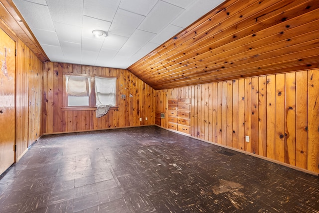 bonus room featuring wooden walls and vaulted ceiling