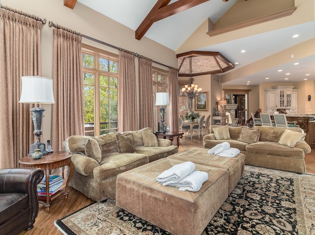 living room featuring a notable chandelier, hardwood / wood-style floors, beamed ceiling, and high vaulted ceiling