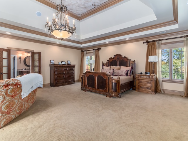 carpeted bedroom with ornamental molding, a tray ceiling, and an inviting chandelier