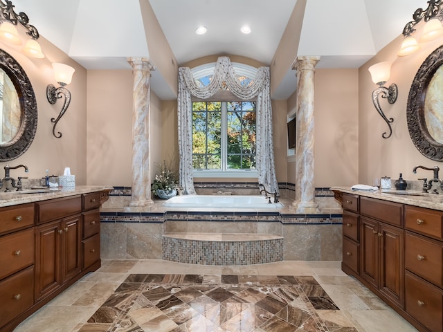 bathroom featuring vanity, ornate columns, a relaxing tiled tub, and lofted ceiling