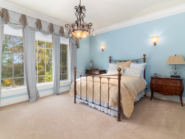 carpeted bedroom with ornamental molding and a chandelier