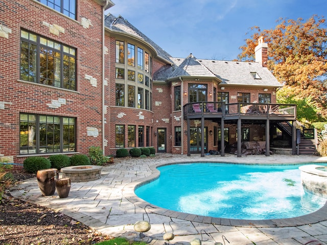 view of pool with a deck and a patio