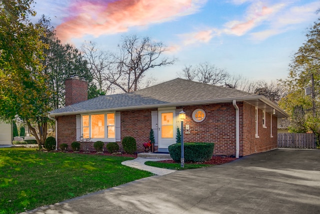 ranch-style house featuring a lawn