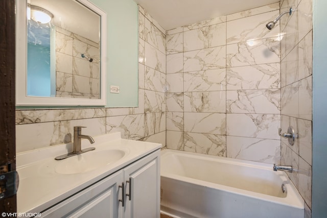 bathroom featuring vanity, tiled shower / bath combo, and tile walls