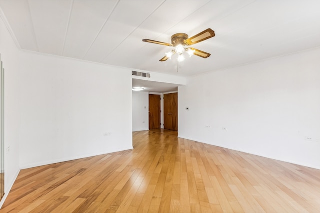 empty room with ornamental molding, light hardwood / wood-style floors, and ceiling fan