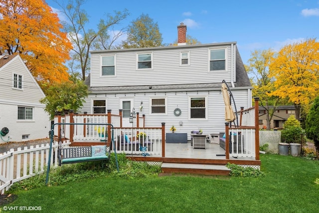 back of house featuring a yard and a deck