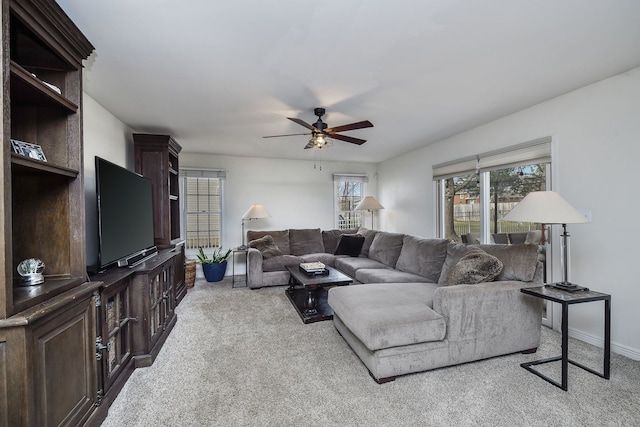 carpeted living room featuring ceiling fan