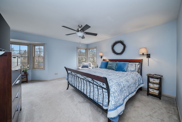 carpeted bedroom featuring ceiling fan and multiple windows