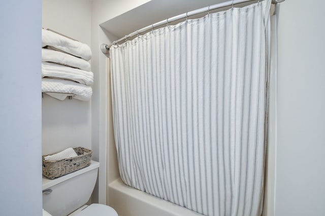 bathroom with shower / tub combo and toilet