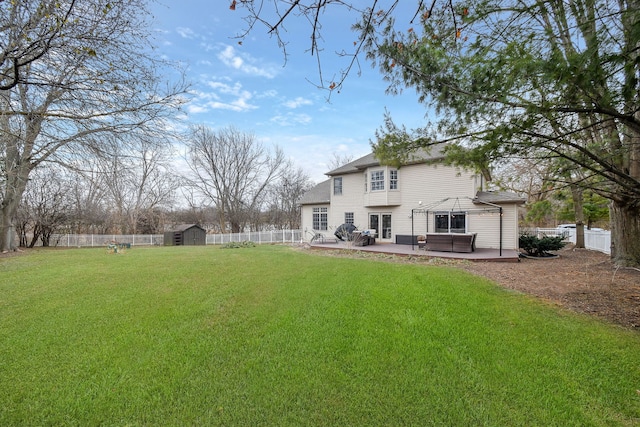 rear view of house featuring a patio, a storage unit, and a lawn