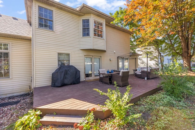 wooden deck featuring a gazebo, an outdoor hangout area, and a grill