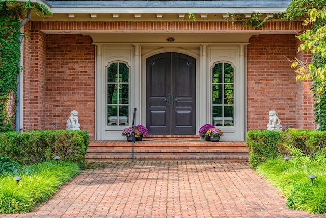 view of exterior entry featuring covered porch