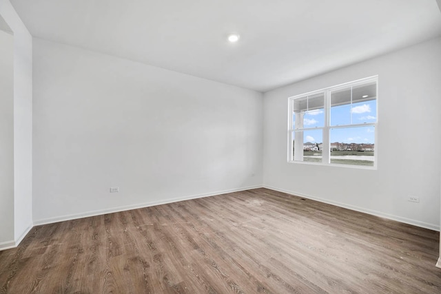 spare room with dark hardwood / wood-style floors