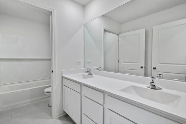 full bathroom featuring toilet, vanity,  shower combination, and tile patterned flooring