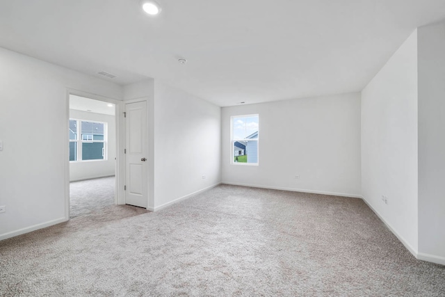 carpeted empty room with a wealth of natural light