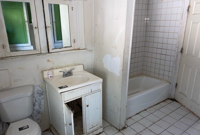 bathroom with vanity, toilet, and tile patterned floors