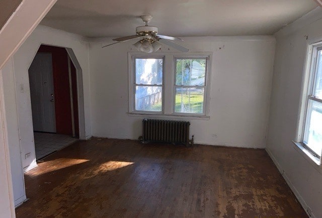 bonus room with radiator heating unit, dark hardwood / wood-style floors, and ceiling fan