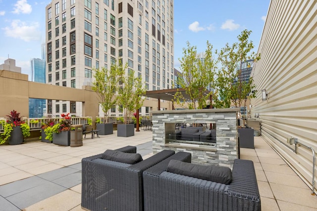 view of patio / terrace with an outdoor living space with a fireplace