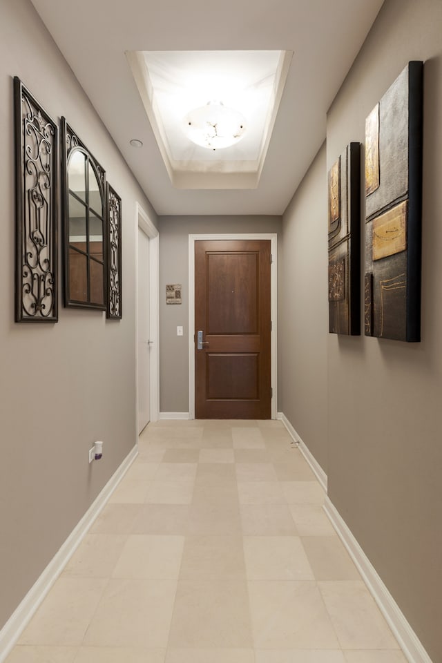 hallway featuring a raised ceiling