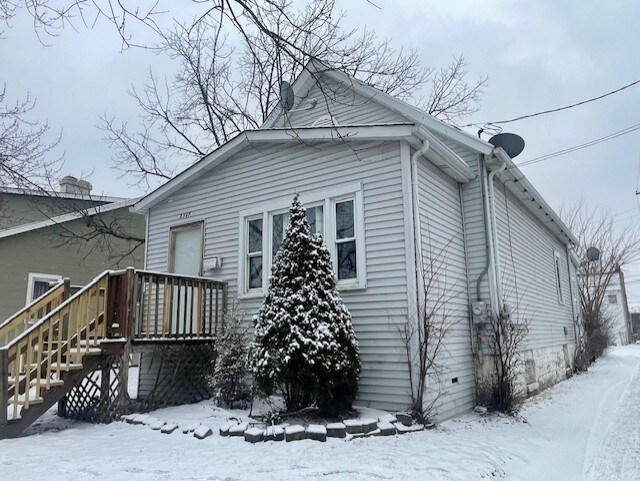 rear view of property with a wooden deck