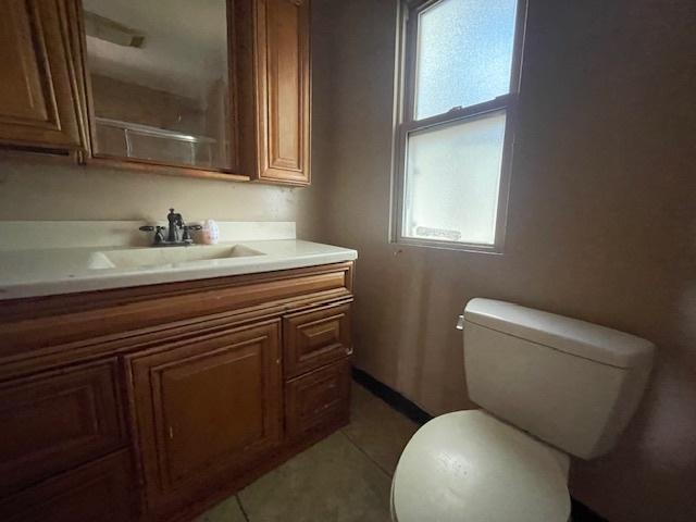 bathroom featuring tile patterned floors, toilet, and vanity