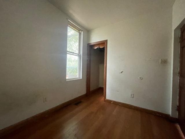 unfurnished room with hardwood / wood-style floors