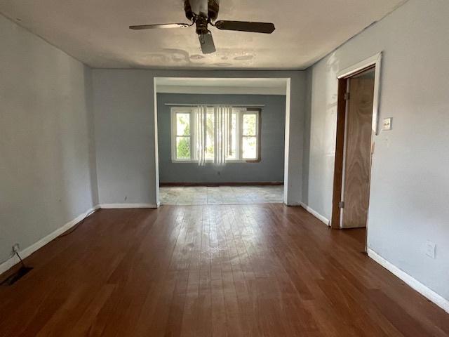 spare room with ceiling fan and dark hardwood / wood-style flooring