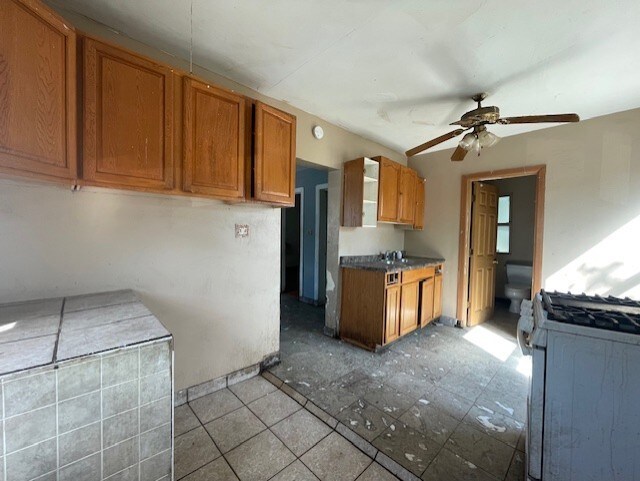 bathroom featuring vanity, walk in shower, toilet, and tile patterned floors