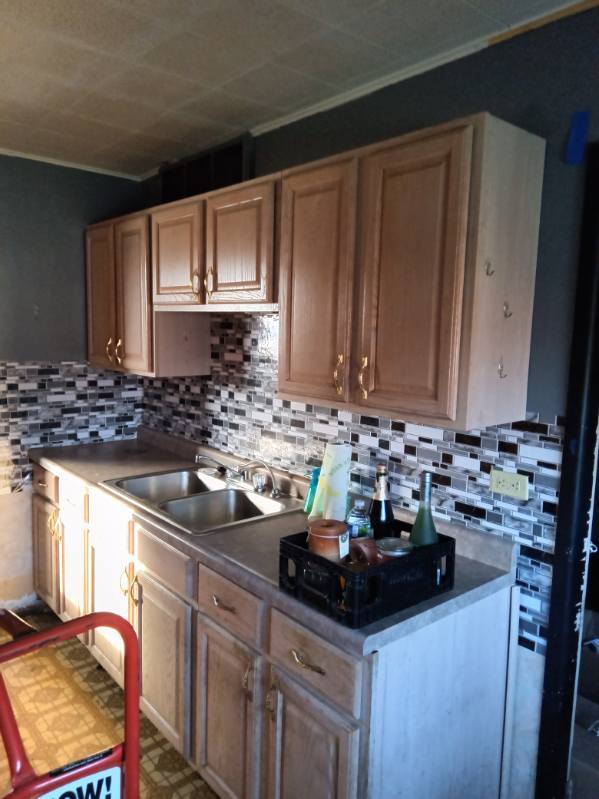 kitchen featuring sink, light brown cabinets, and tasteful backsplash