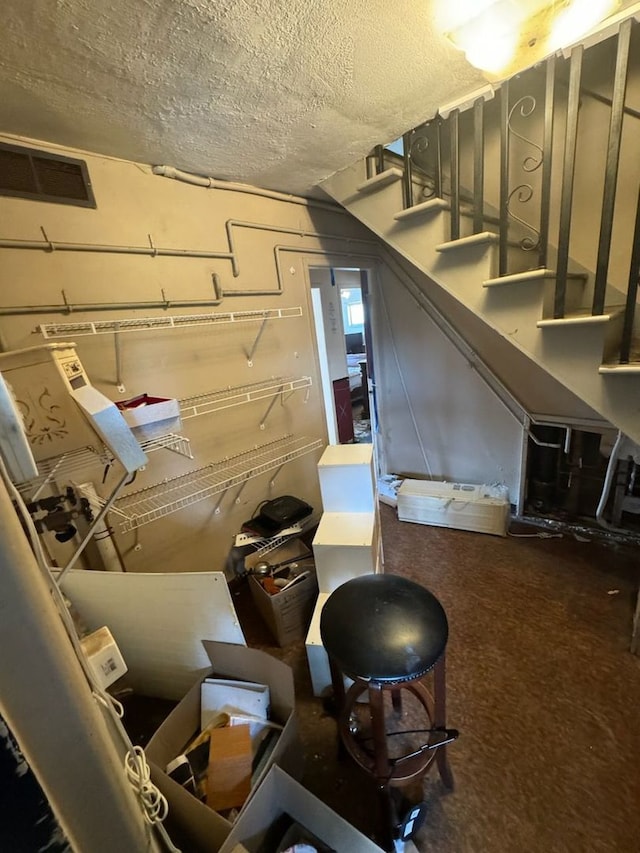 basement featuring a textured ceiling