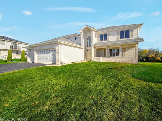 view of front of home with a garage and a front lawn