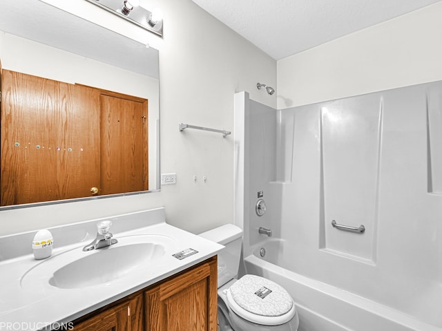 full bathroom featuring vanity, a textured ceiling, toilet, and shower / washtub combination