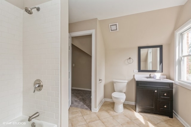 full bathroom featuring toilet, tile patterned floors, vaulted ceiling, tiled shower / bath, and vanity