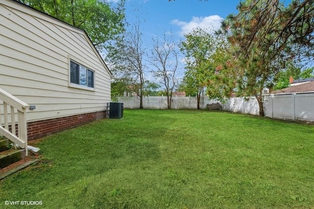 view of yard featuring central air condition unit and a fenced backyard
