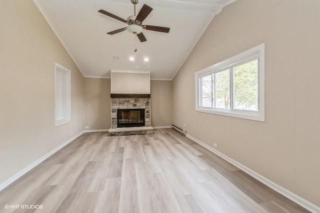 unfurnished living room featuring ceiling fan, light wood-type flooring, vaulted ceiling, ornamental molding, and a stone fireplace