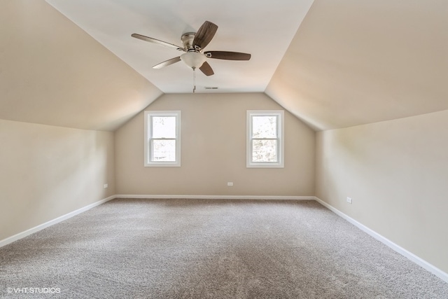 bonus room with lofted ceiling, carpet, and ceiling fan