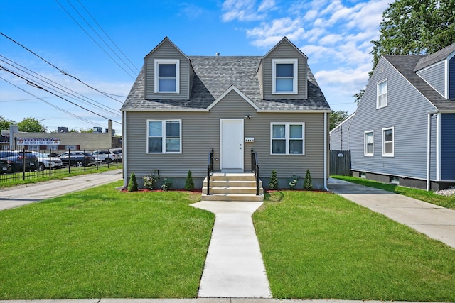 cape cod-style house featuring a front lawn