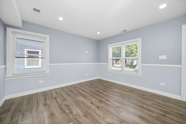 spare room with hardwood / wood-style flooring