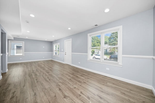 unfurnished living room featuring light hardwood / wood-style floors and a wealth of natural light