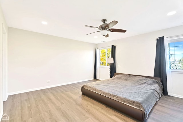 bedroom with ceiling fan and hardwood / wood-style flooring