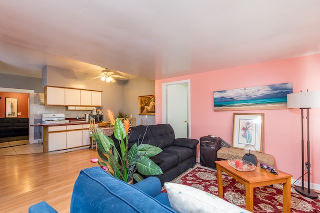 living room featuring light hardwood / wood-style flooring and ceiling fan