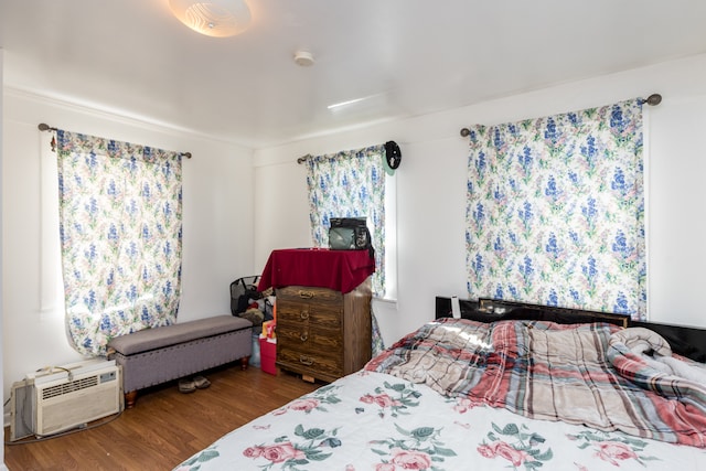 bedroom with hardwood / wood-style flooring