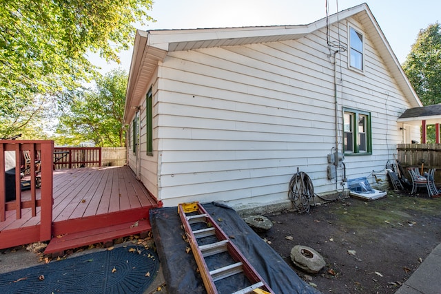 view of property exterior with a wooden deck