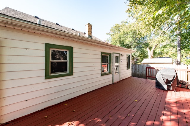 wooden deck with a grill