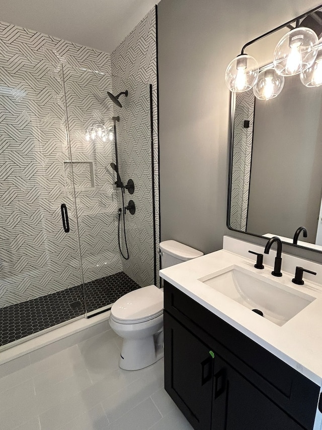 bathroom with vanity, toilet, tile patterned floors, and an enclosed shower