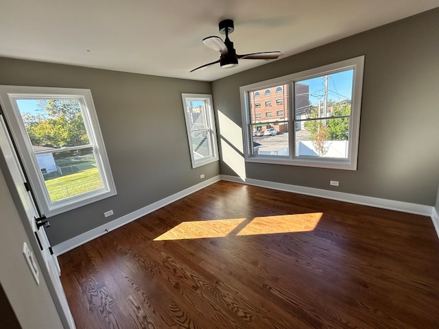 spare room featuring dark wood-type flooring and ceiling fan