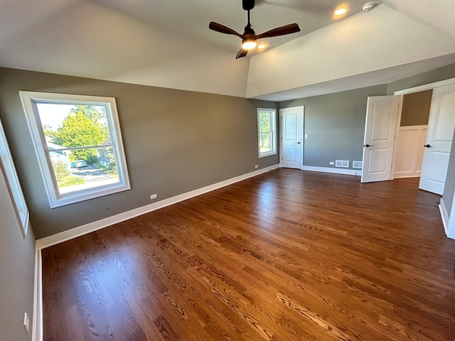 unfurnished room with ceiling fan, vaulted ceiling, and dark hardwood / wood-style floors