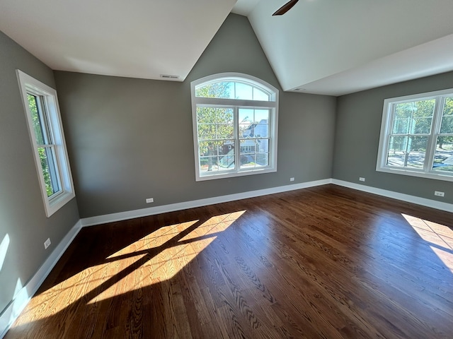 spare room featuring ceiling fan, vaulted ceiling, and dark hardwood / wood-style flooring